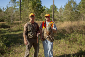 2 hunters in Baldwin County on a guided hunt showing off their pheasant.